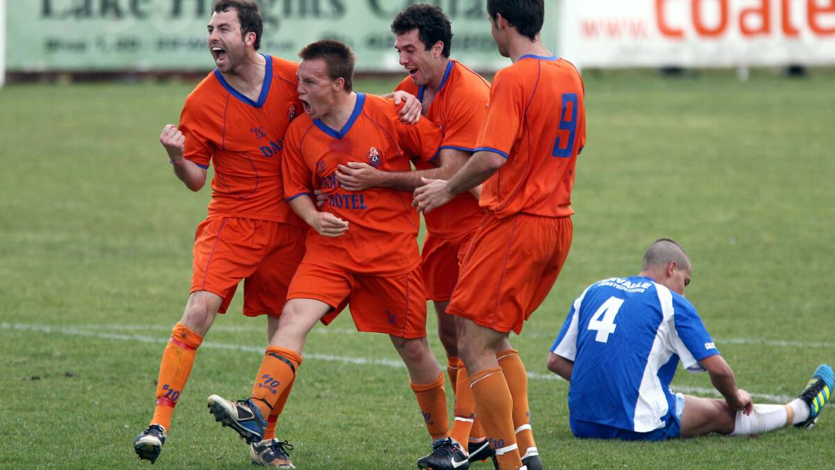 BACK THEN: Sam Munro (centre) celebrates scoring for Dandaloo in their win over Tarrawanna in 2011. Picture: ANDY ZAKELI