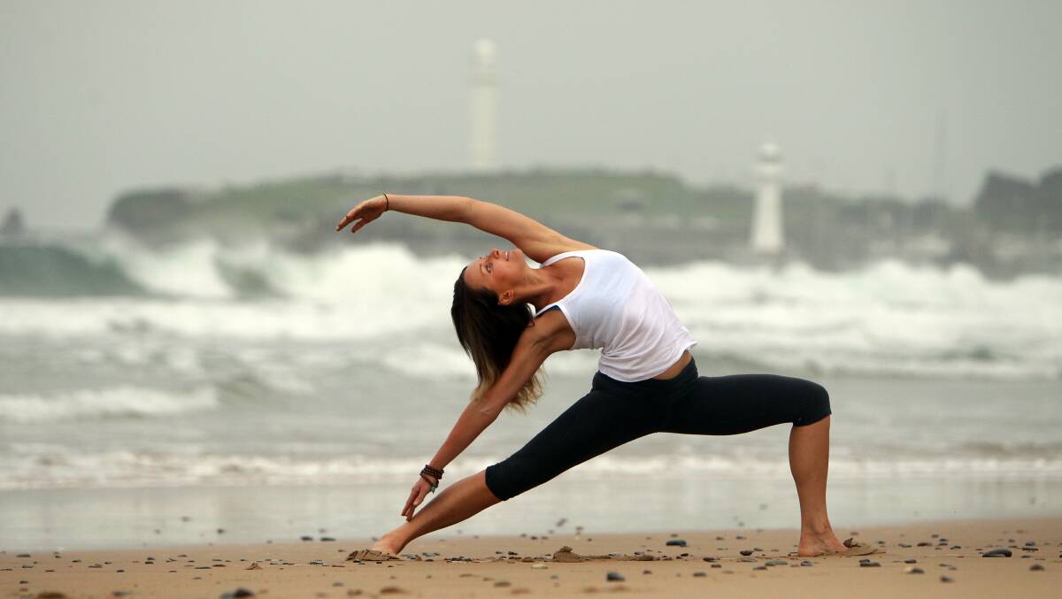 Lis White makes a yoga pose on North Wollongong beach. Picture: Sylvia Liber
