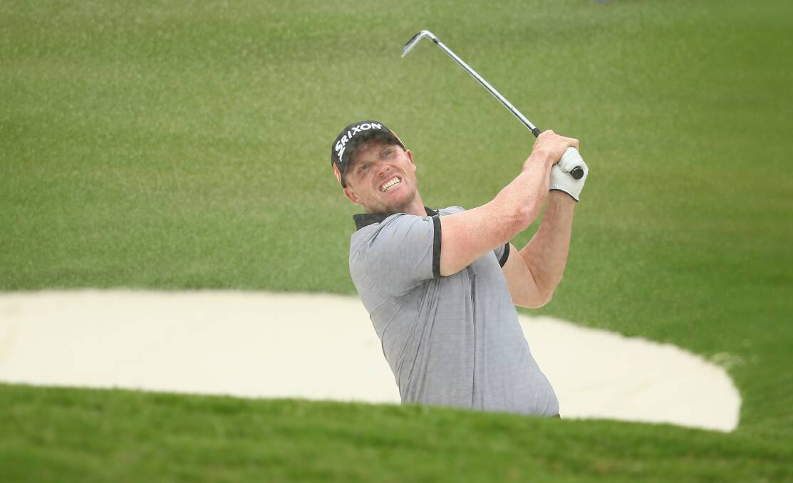 SAND BLASTER: Lincoln Tighe plays from the bunker at the Australian Open. Picture: Getty Images