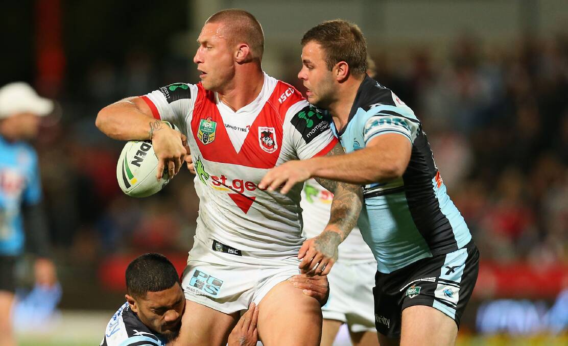 OFFLOAD: Forward Tariq Sims looks to pass against Cronulla last season. Picture: Jason McCawley/Getty Images