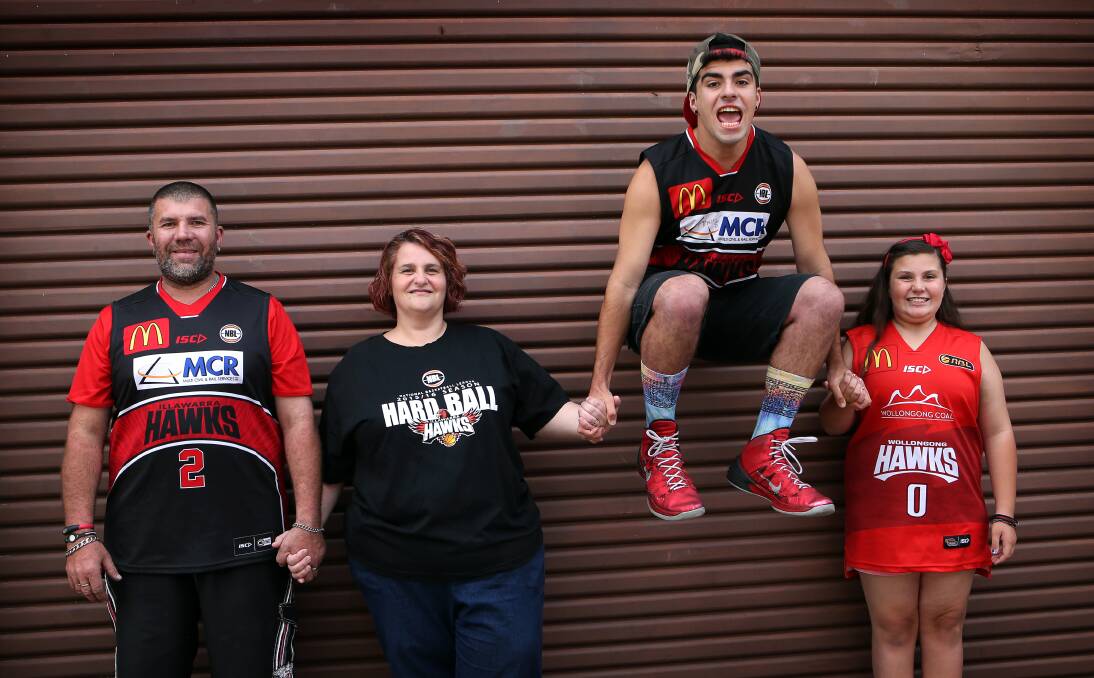 JUMPING FOR JOY:  Tracy, Pat, Anthony (wearing Oscar Foreman's shoes) and Isabella Ellem are excited to win the Hawks VIP passes for the Kings game on Monday. Picture: Sylvia Liber.