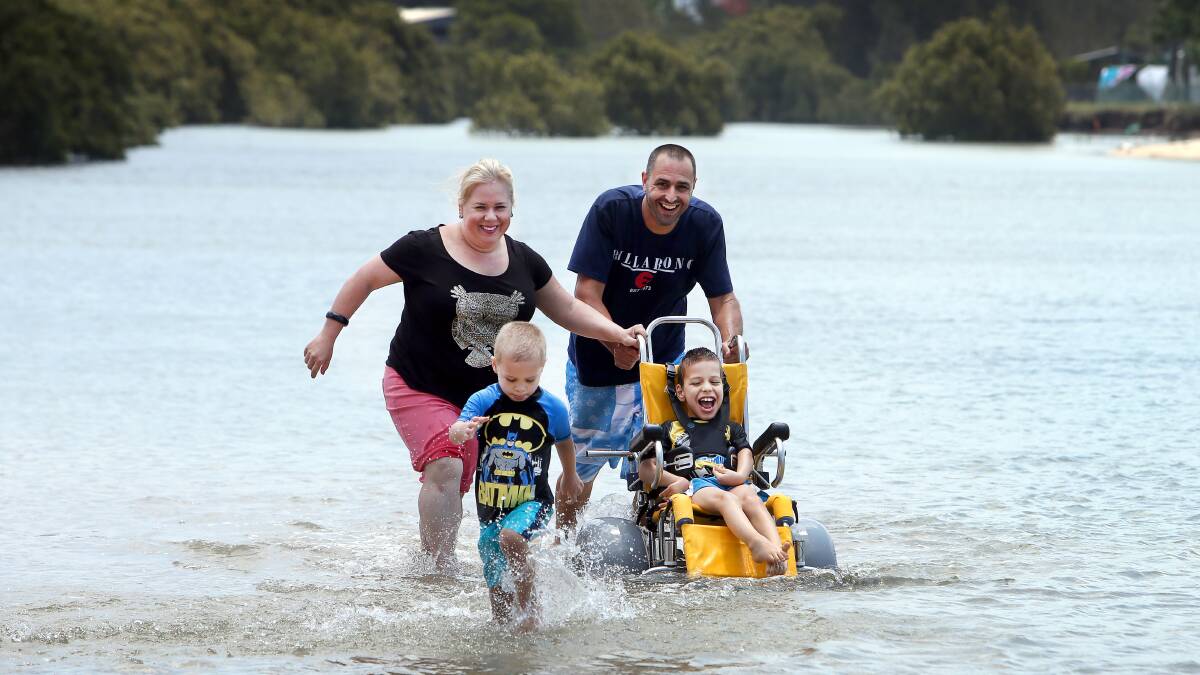 Life-changing: Seven-year-old Dane Robinson can enjoy many days at the beach with his parents Sally and Grant and little brother Cooper thanks to a gift from the Starlight Children's Foundation. Picture: Sylvia Liber