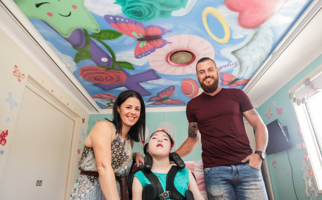 Precious piece: Sophie Macaulay with her mother Shanna Priestly and aerosol artist Anthony Jones who painted the mural. Picture: Georgia Matts 