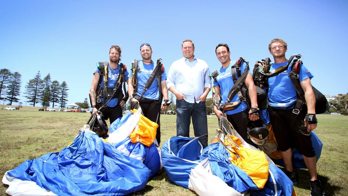 GETTING ON WITH IT: Tandem skydivers Tony Hays, John Martin, Tahi-Paul Munroe and Adam Long join Skydive the Beach director Anthony Ritter. PICTURE: Sylvia Liber.