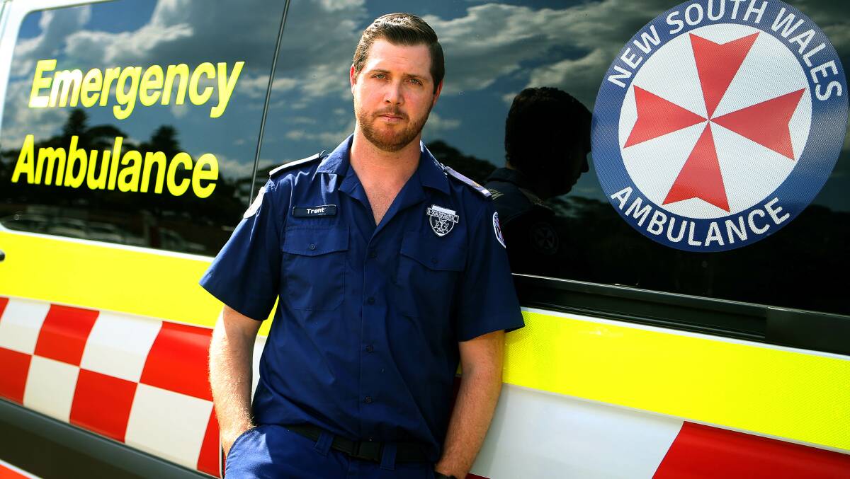 Hot and bothered: Another summer, still the same stuffy uniform - Illawarra paramedic Trent McLennan says he and his colleagues are suffering heat stress from uncomfortable polyester shirts. Picture: Sylvia Liber