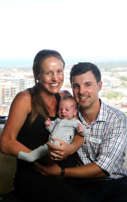 Family affair: Dr Melanie Tolnay and Dr Myles Barnett, with three-week-old Henry, on the first day of their internship at Wollongong Hospital. Picture: Sylvia Liber