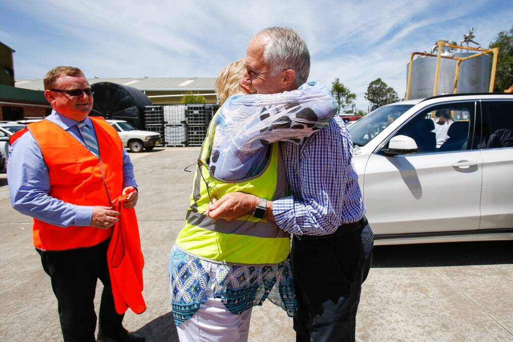 Gilmore MP Ann Sudmalis embraces Prime Minister Malcom Turnbull during his visit to a Nowra chemical business on Friday. Picture: Adam McLean