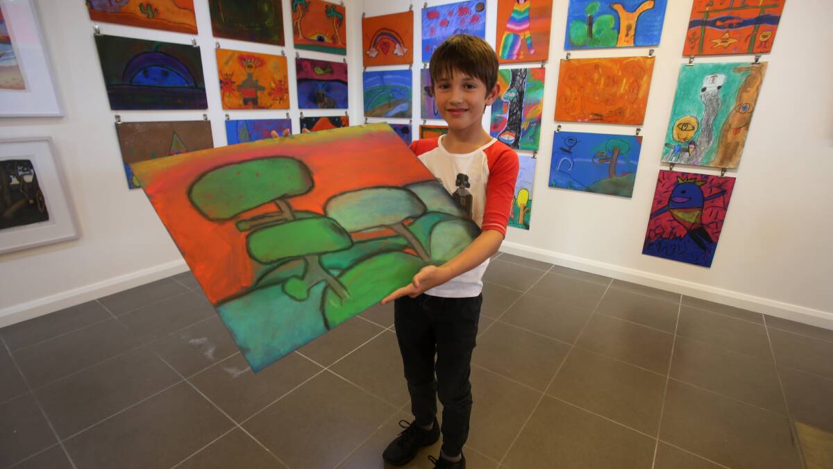 INSPIRATION: Lucas Noacco, 9, from Thirroul with his Reg Mombassa inspired artwork which was created with help from the Artspace artists in Corrimal. Picture: Robert Peet