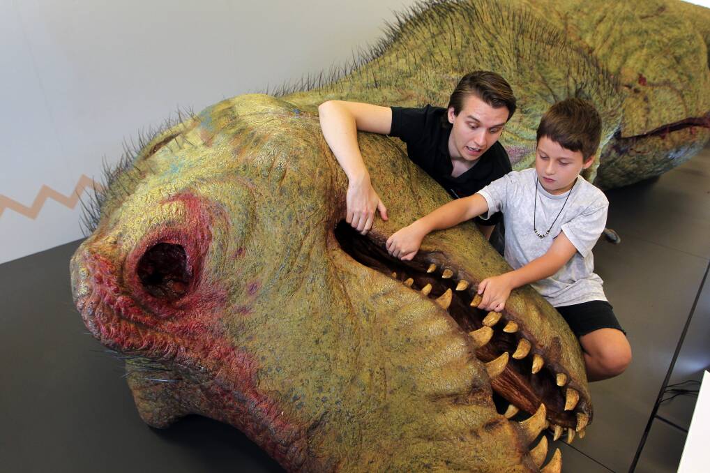 SURREAL: Jackson Eather from the Australian Museum with Kai Spinks at the life like T-rex autopsy exhibit at Stockland Shellharbour until April 25. Picture: Sylvia Liber