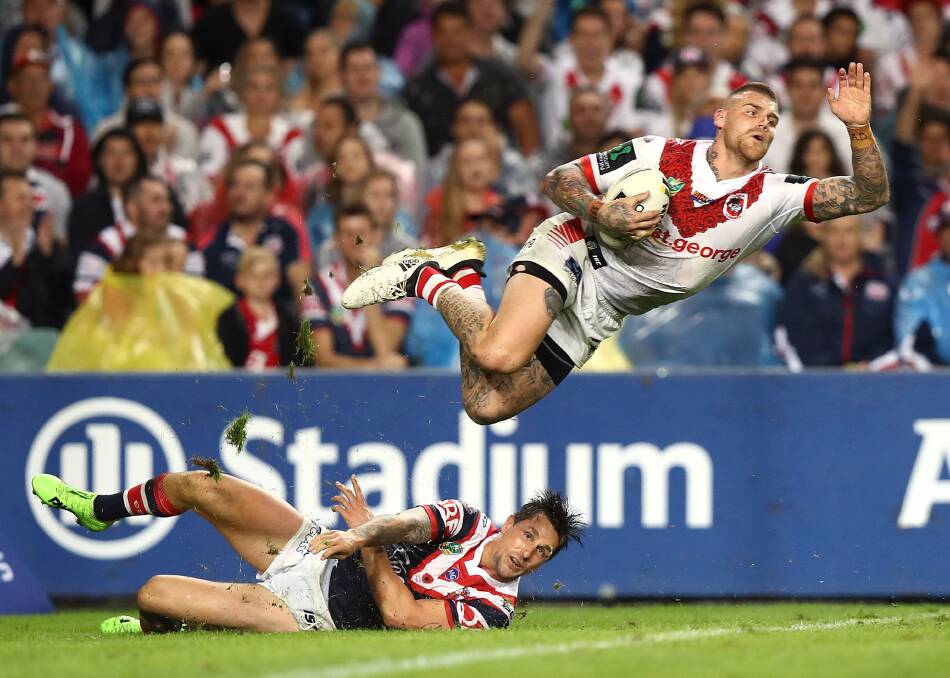 Fly away: Josh Dugan and Mitchell Pearce during the Anzac Day clash. Picture: Ryan Pierse/Getty Images