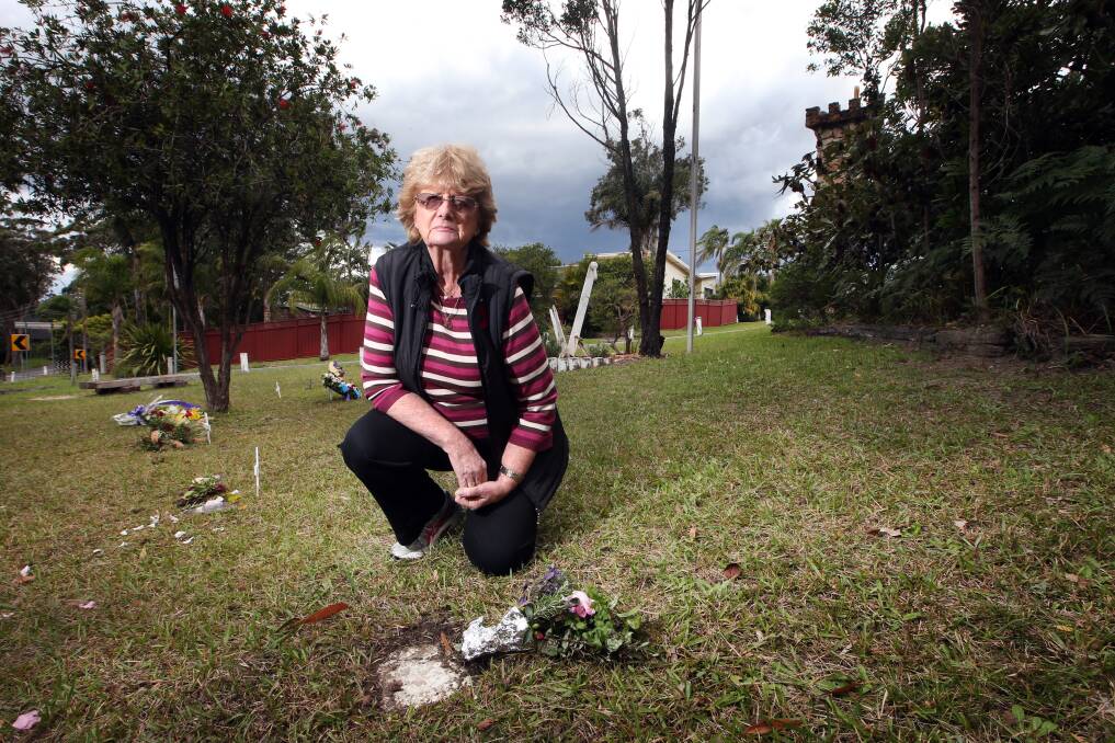 Saddened: Jenny Donohoe in front of the Stanwell Tops Lyons memorial to fallen soldiers. The plaques bearing their names have been vandalised recently. Picture: Sylvia Liber