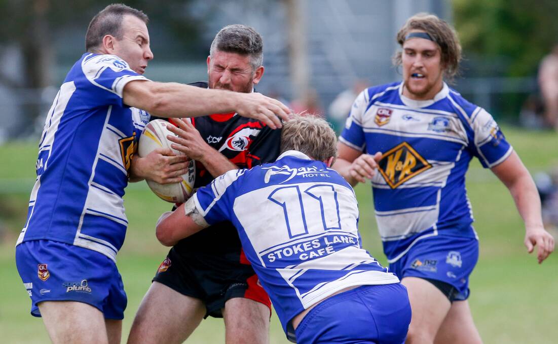 Wrapped up: Collegians' Matt Tilley is confronted by Thirroul defenders on Saturday. Picture: Adam McLean