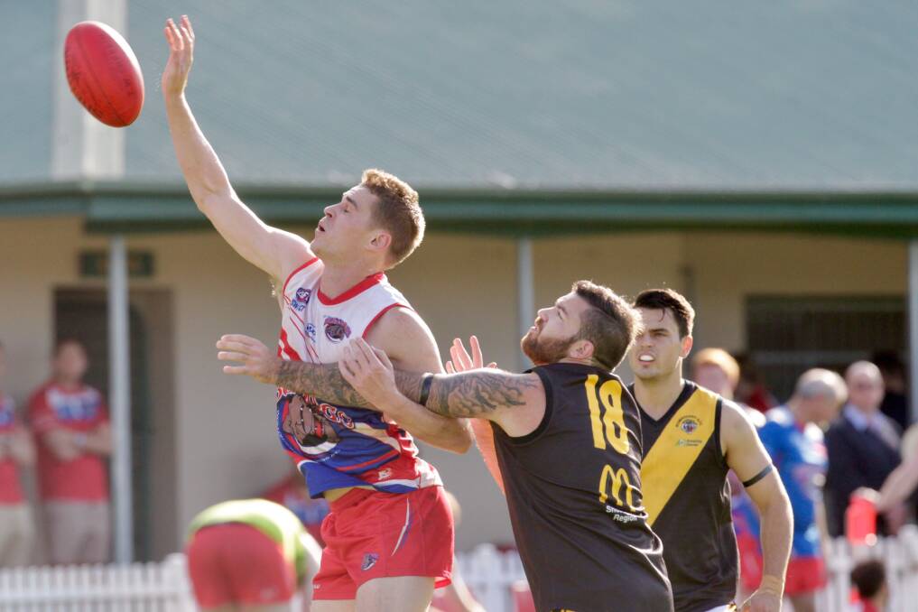 In front: Wollongong Bulldogs player Leo Stevens takes on Bomaderry earlier this season. Picture: Adam Mclean
