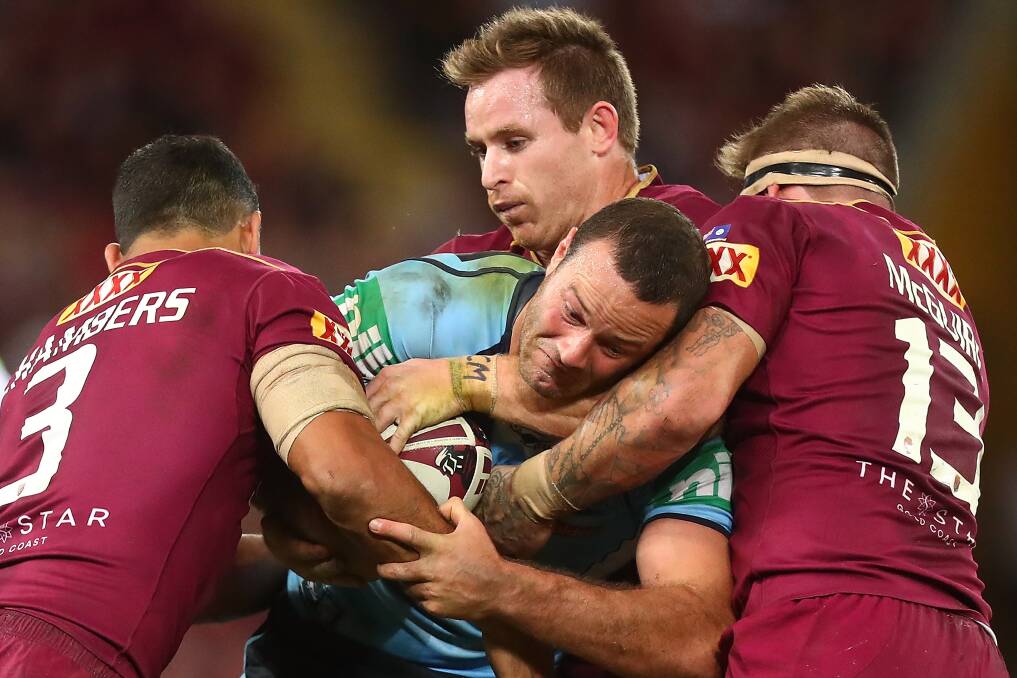 Caught: NSW captain Boyd Cordner is tackles by the Maroons. Picture: Getty Images