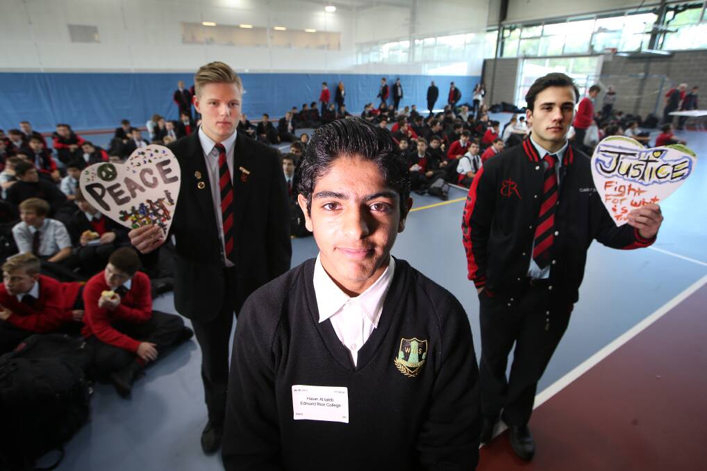 TAKING A STAND. Edmund Rice College students Will Ramsay and Julian Cable with Syrian refugee Hasan Al Taleb. Picture: Sylvia Liber