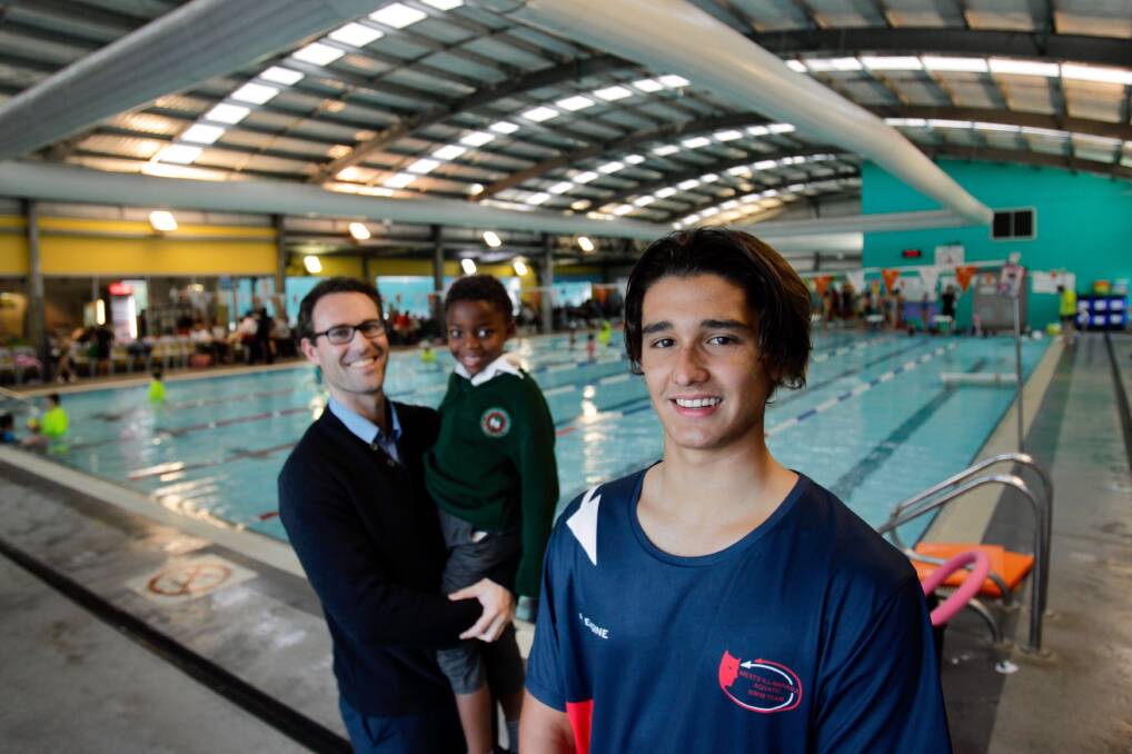 Mark Dombkins from the Forever Projects with his son Charlie and swimmer Brendan Eastman at McKeon's swim school. Picture: Adam Mclean
