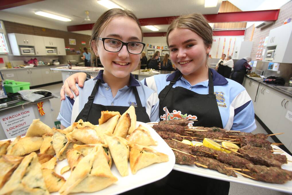 YUMMY FOOD: Lake Illawarra High School students Jennifer Grujevski and Jasmine Muldoon took part in the Multicultural Cook-off event. Picture: Robert Peet