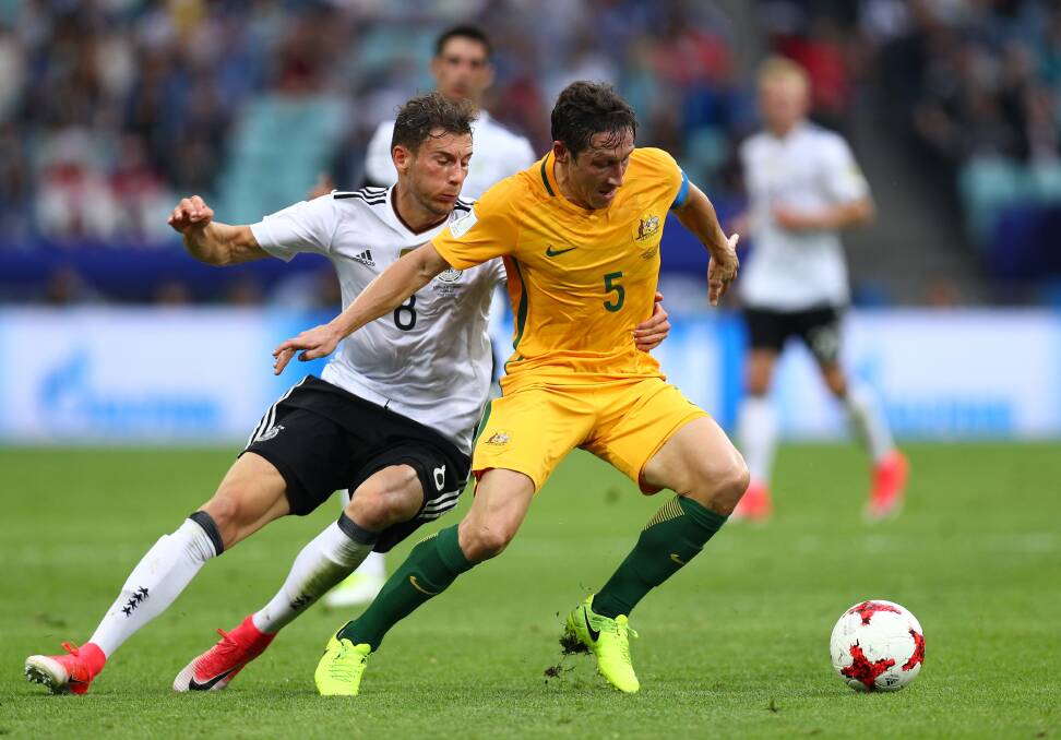Battle: Mark Milligan in possession against Germany in Russia. Picture: Buda Mendes/Getty Images