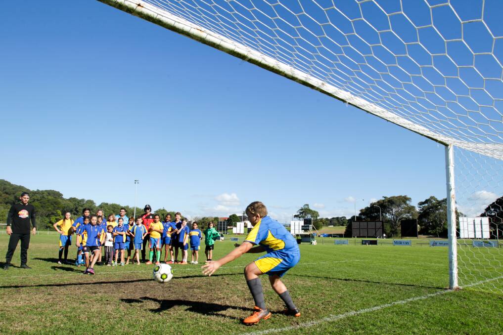 Jade North with kids from Jervis Bay school taking part in the 'Kickin' with a Cuz' football clinic at Albert Butler Memorial Park. Picture: ADAM McLEAN