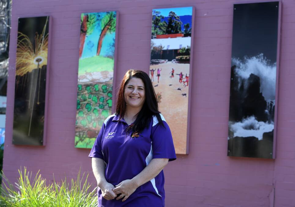 STUDENT ART: Wollongong Youth Centre's youth services coordinator Alison Bradford shows off some of the outside panels. Picture: Robert Peet