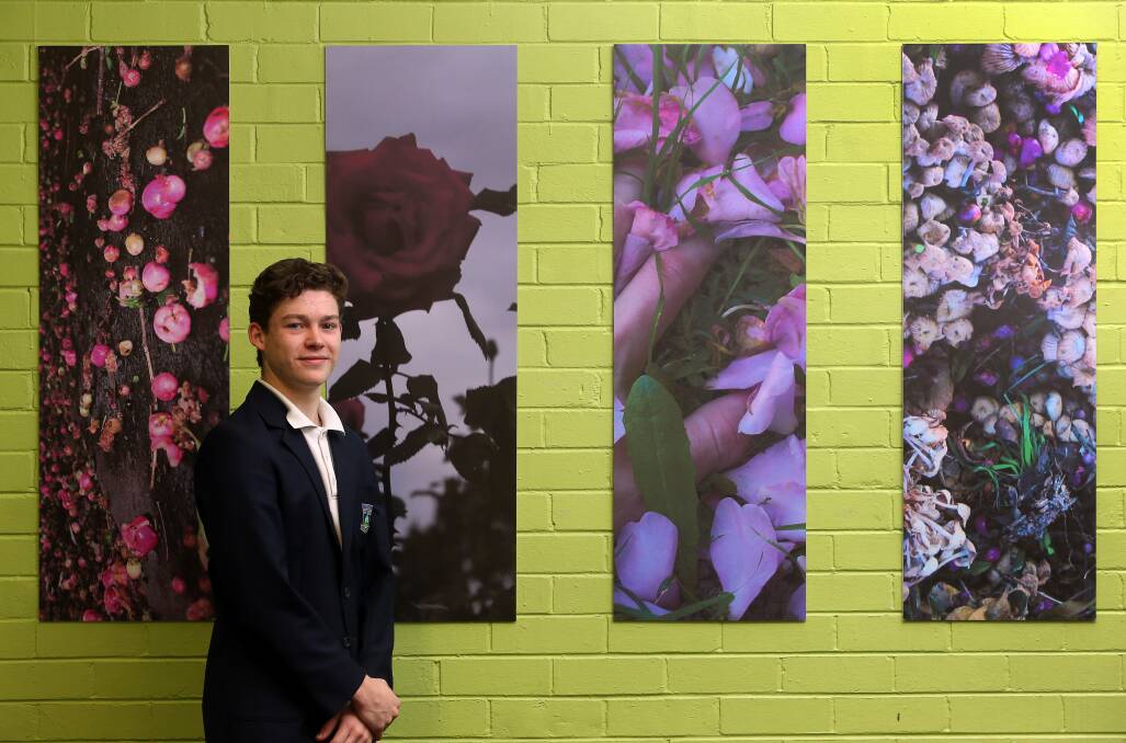 CAPTURING BEAUTY: Figtree High School student Sam Birch with some of the photographs featured in the 'I Love Wollongong Because' project. Picture: Robert Peet