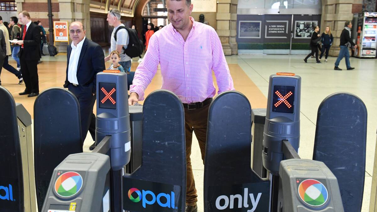 NSW Minister for Transport and Infrastructure Andrew Constance goes through an Opal Card turnstile after a press conference at Central Station in Sydney, Sunday, July 9, 2017. (AAP Image/Mick Tsikas) NO ARCHIVING