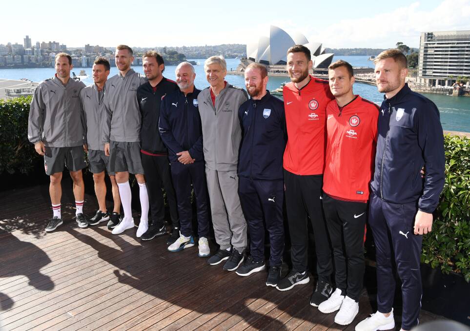 On tour: Arsenal manager Arsene Wenger (centre) with Western Sydney Wanders manager Tony Popovic, Sydney FC manager Graham Arnold and players. Picture: AAP Image/David Moir