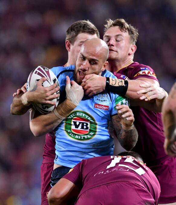 Wrapped up: Blake Ferguson is tackled in game three. Picture: AAP Image/Darren England
