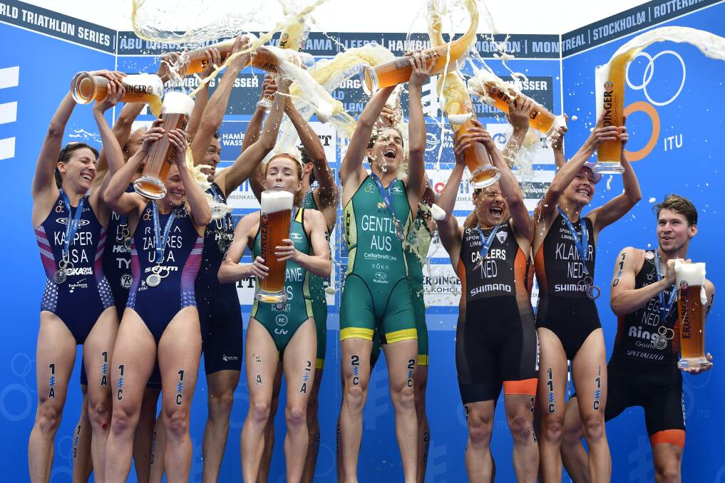 GOLDEN GLOW: The Australian team celebrates winning gold in the triathlon relay in Hamburg. Picture: GETTY IMAGES