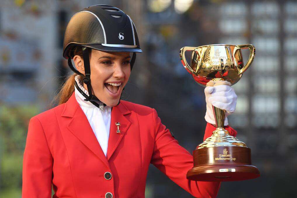 COVETED: Model and ambassador Rachael Finch holds the Melbourne Cup as the tour launch in Sydney on Monday. Picture: AAP