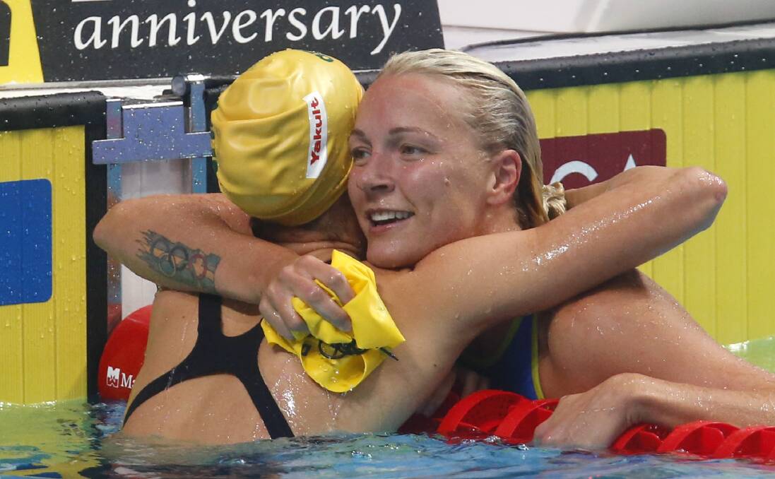 Well done: Sweden's Sarah Sjostrom hugs Australia's Emma McKeon. Picture: AP Photo/Darko Bandic
