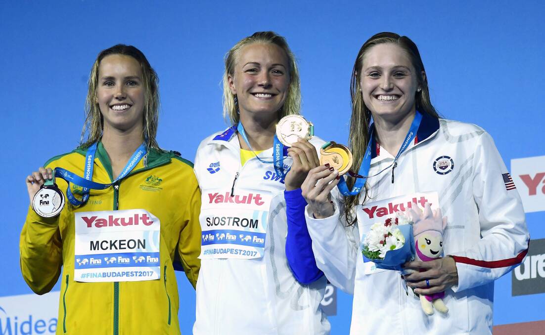 All smiles: Emma McKeon of Australia, gold medal winner Sarah Sjostrom of Sweden and bronze medal winner Keli Worrell ot the United States. Picture: Tamas Kovacs/MTI via AP