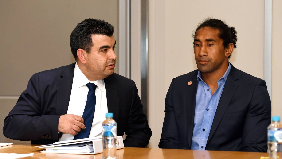 Banned: Canberra Raiders NRL player Iosia Soliola (right) is accompanied by lawyer Nick Ghabar at the  judiciary hearing at Rugby League Central in Sydney on Tuesday. Picture: AAP Image/Paul Miller