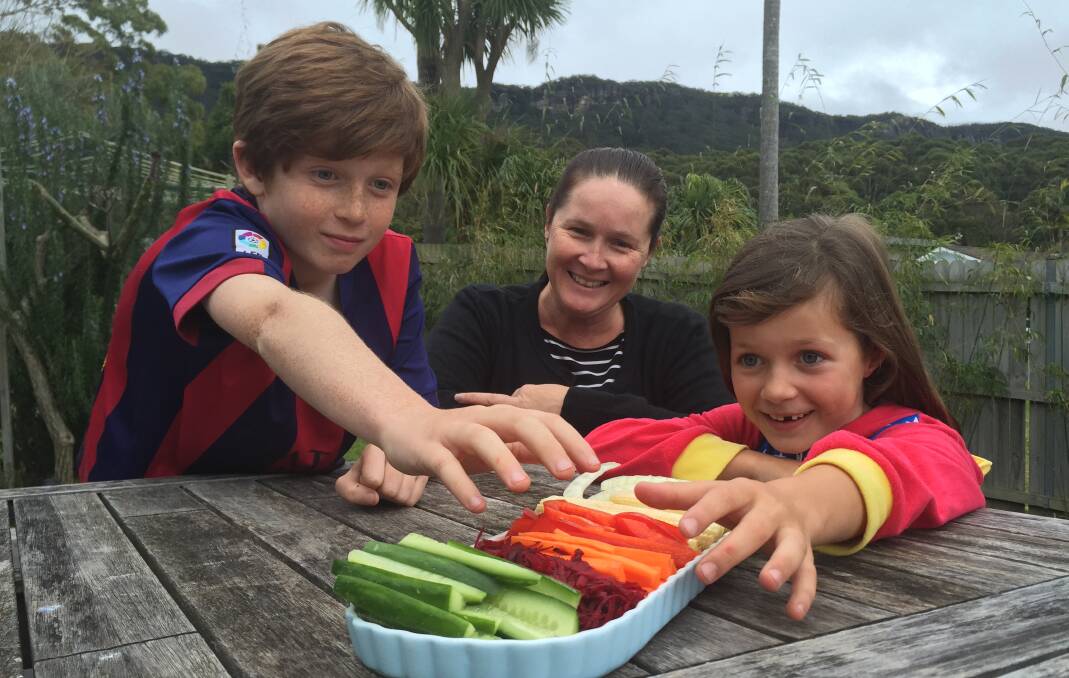 Champs of chomp: Austinmer William and Olivia Soster (with mum Sam) love their vegetables, because they've been brought up on them from an early age. Picture: Ben Langford