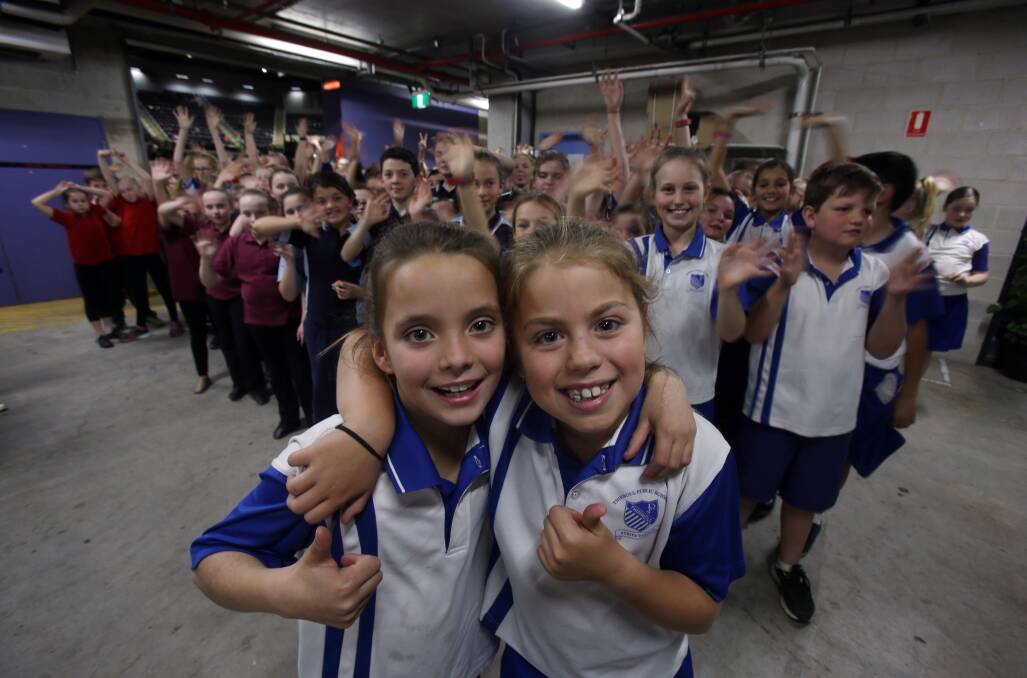 Thirroul Public School students Harper Cooke and Bronte Dengate waiting in the wings ahead of Wednesday's rehearsals. Picture: Robert Peet