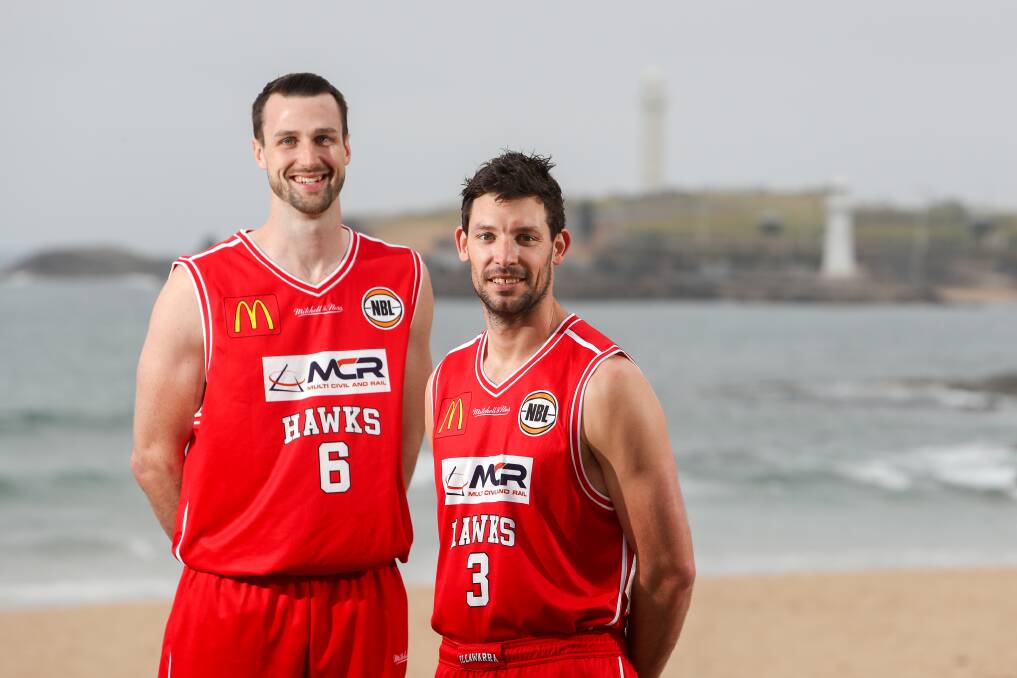 NEW ROLE: Hawks skipper Kevin White with centre AJ Ogilvy at North Wollongong Beach before the season tips off on Friday night. Picture: ADAM McLEAN