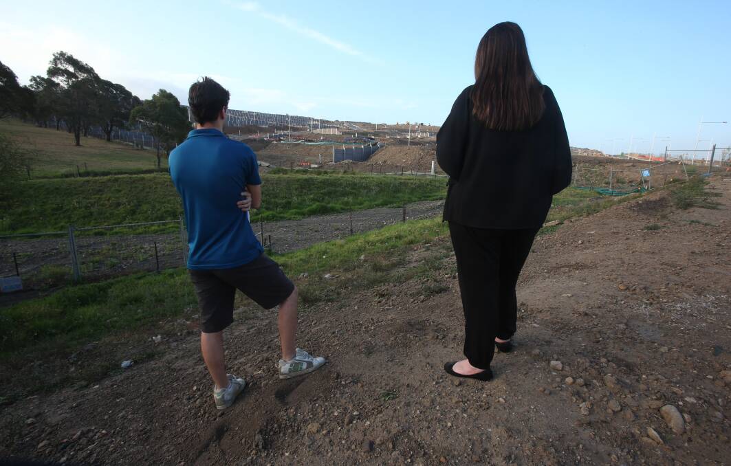Costly delay: Concerned Calderwood property buyers look over their land. Picture: ROBERT PEET.