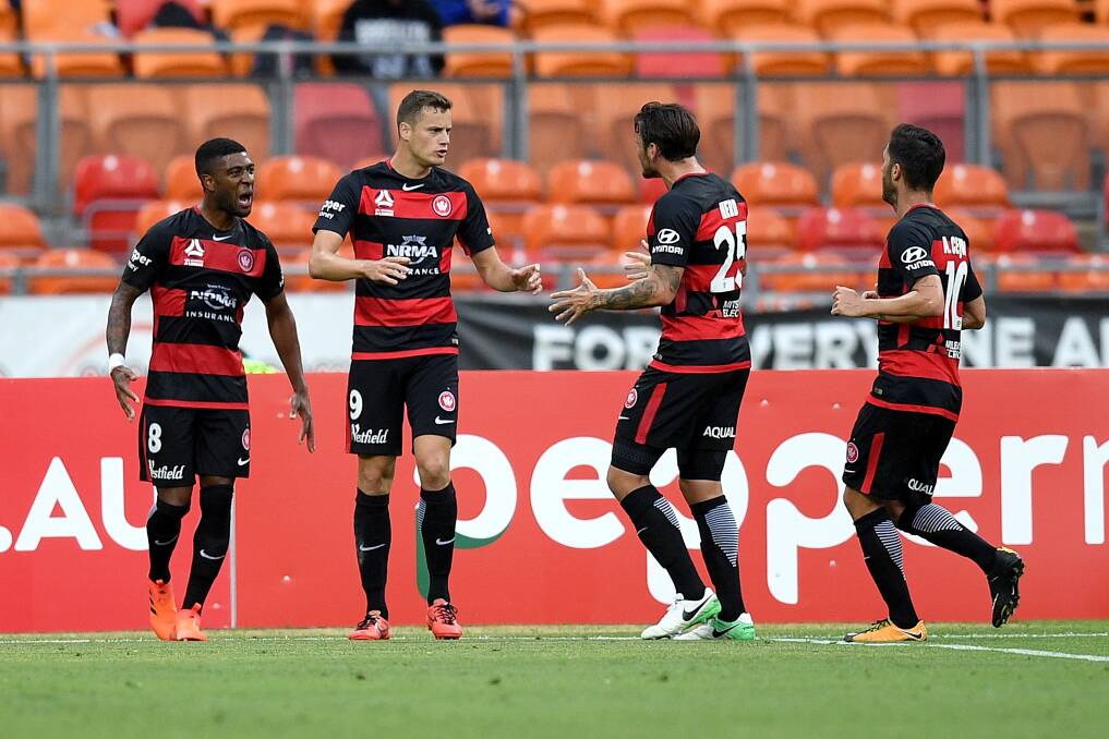 Awesome foursome: Wanderers' Oriol Riera is congratulated by teammates. Picture: AAP Image/Dan Himbrechts