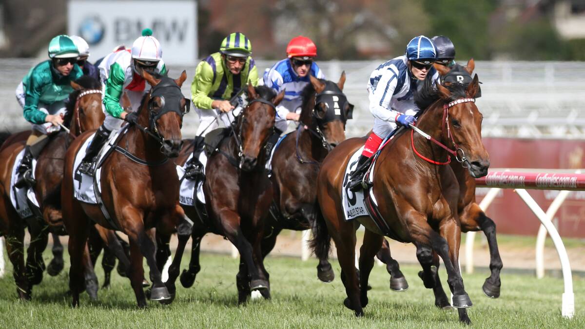 Craig Williams riding Amelie's Star leads them past the post the first time around during the Caulfield Cup. Picture: AAPImage/George Salpigtidis
