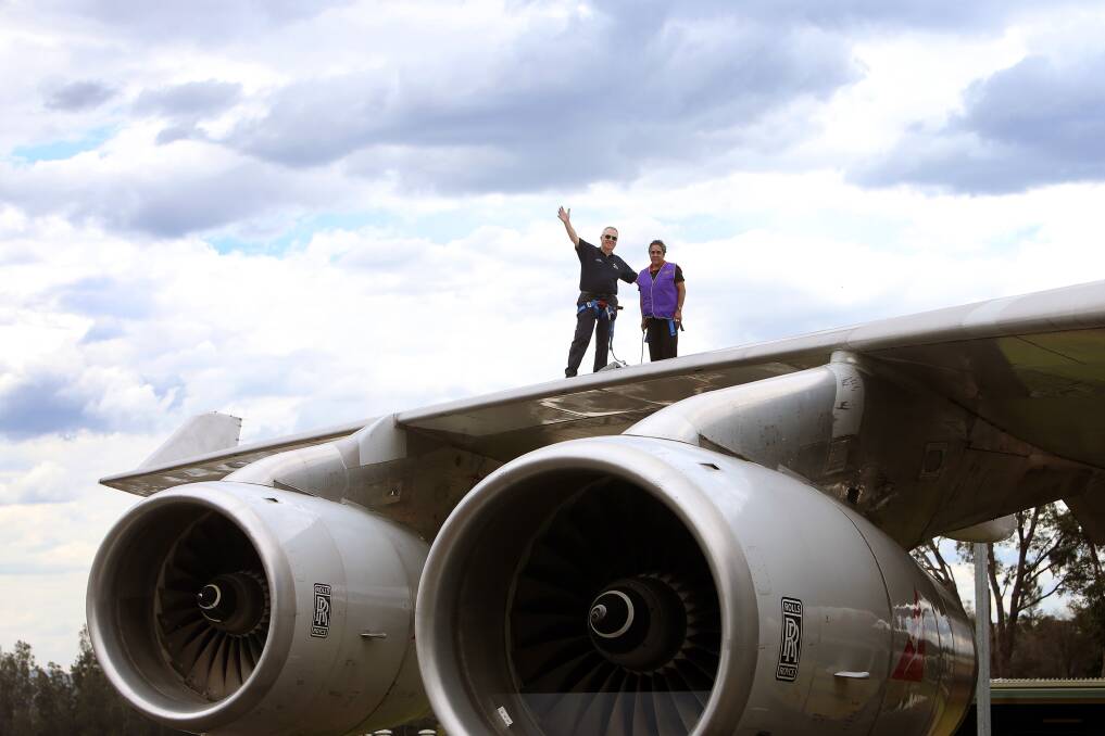 Aboriginal Elder Aunty Lindy Lawler with Phil Mason from HARS doing a Wing Walk on the Boeing 747 at the Illawarra Regional Airport. Picture: Sylvia Liber
