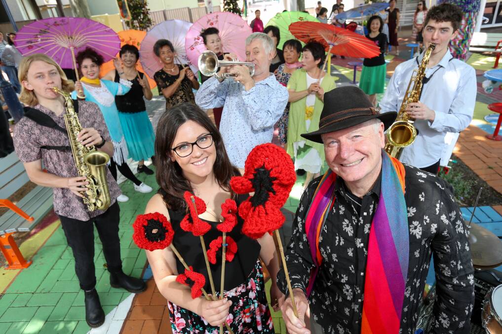COMMUNITY: Lord Mayor Councillor Gordon Bradbery OAM and ​textile artist Stacie Sims holding poppies created for Wollongong's annual arts festival Viva La Gong. Picture: Adam McLean