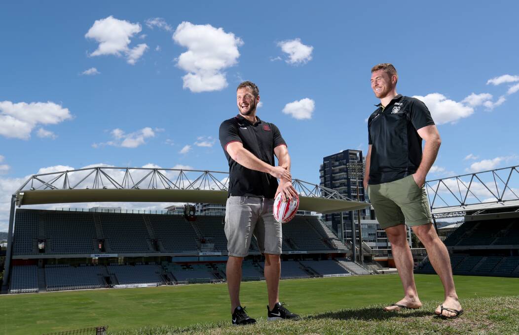 SHOW TIME: Wigan Warriors and England captain Sean Loughlin with Hull FC and England player Scott Taylor ahead of their match in Wollongong. Picture: Adam McLean