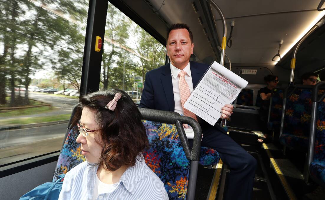 sign up: Wollongong MP Paul Scully collecting petitions on the Gong Shuttle. He believes the government has disliked the service for years. Picture: Sylvia Liber