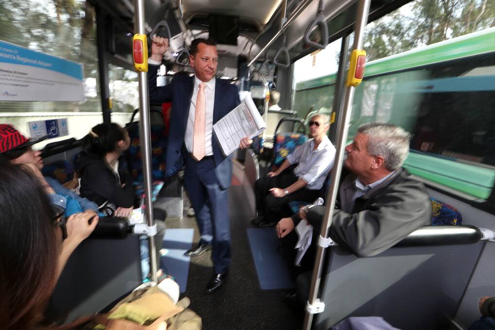 Sign up: Wollongong MP Paul Scully riding the Gong Shuttle on Friday morning to collect signatures on a petition to keep the service free. Picture: Sylvia Liber