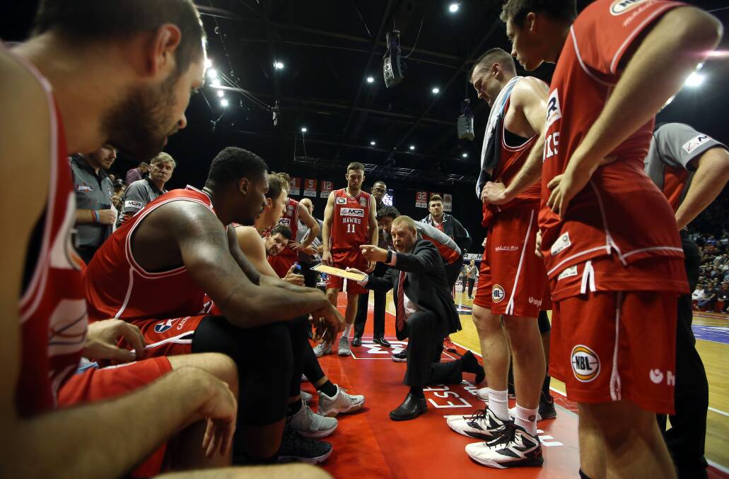 Ready: Hawks coach Rob Beveridge addresses the players at a time-out. Picture: Sylvia Liber