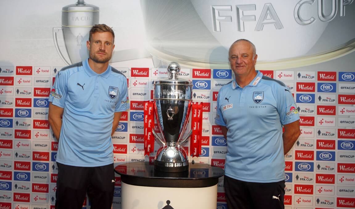 Cup dream: Sydney FC goalkeeper Andrew Redmayne and coach Graham Arnold  with the FFA Cup trophy. Picture: AAP Image/Daniel Munoz