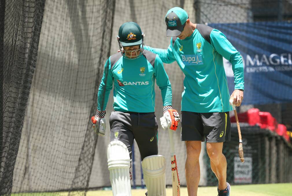 Pain in the neck: David Warner (left) leaves the nets after only facing two balls. Picture: AAP Image/Jono Searle

