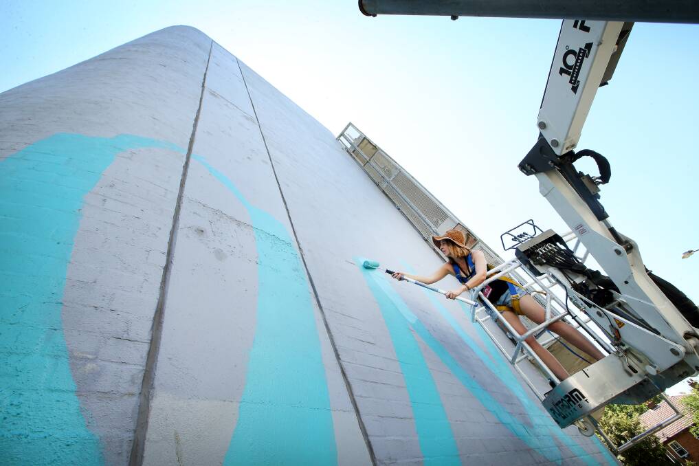 RE-CREATION: Artist Claire Foxton works on her giant mural on Friday, which will be a tribute wo Wendy Lawrence and her dog, in Court Lane. Picture: Sylvia Liber
