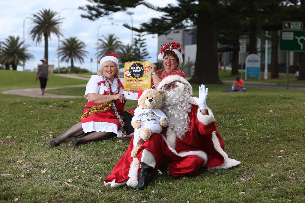 SNAPPED: Santa Claus is caught relaxing in Wollongong's Lang Park with Karen Walker and Margaret Biggs on Wednesday ahead of his weekend's appearance in the region for Santa Fest Christmas Carols. Picture: Robert Peet