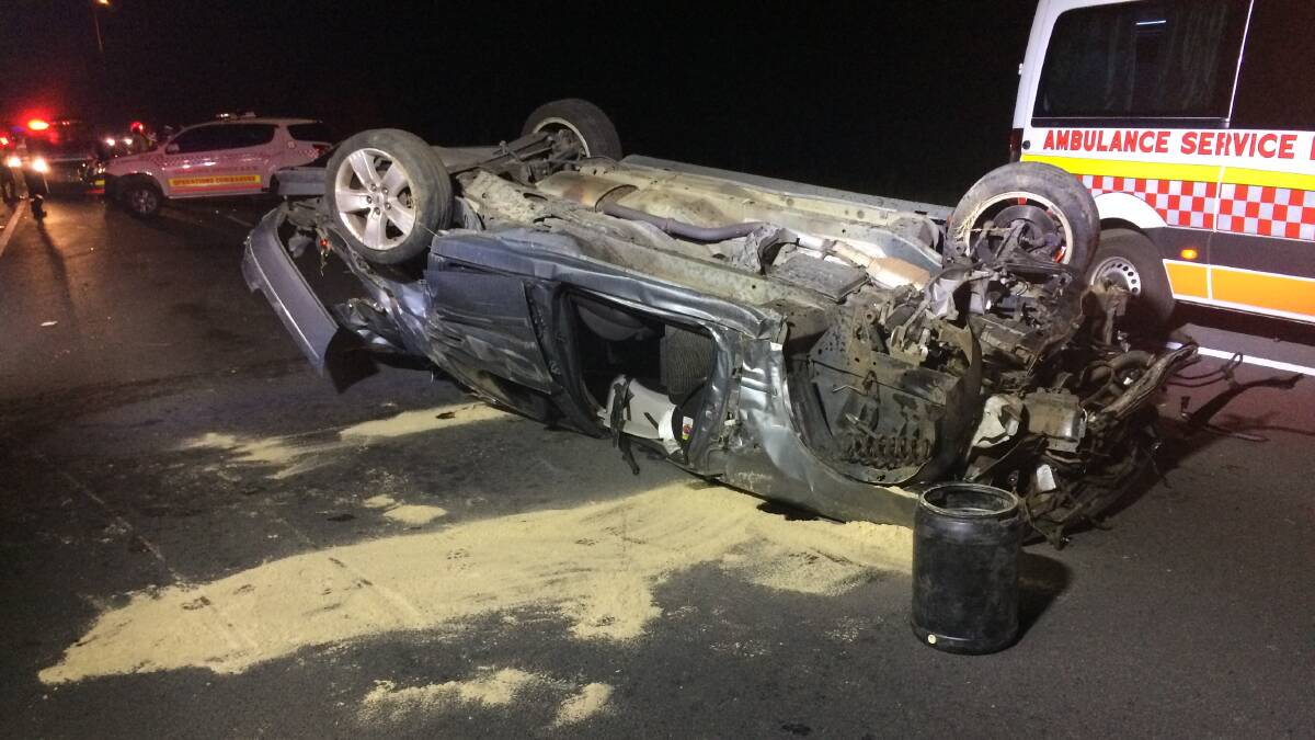 An overturned car involved in a single vehicle accident at on the M1 near the Kanahooka on ramp early Sunday morning. Picture: Supplied
